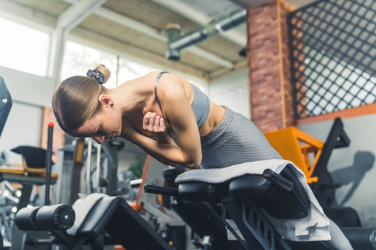 young woman working out on the machine at the gym, fitness and active lifestyle. High quality photo