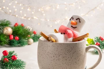 Fototapeten Mug with hot chocolate with melted marshmallow snowman. Merry Christmas drink. Happy Holiday card © azurita