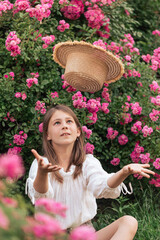 beautiful girl among pink roses outside