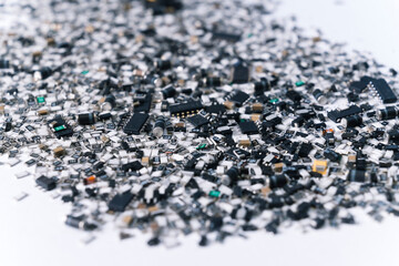 Various electrical components for circuit board mixed and scattered on white surface. Silver and black. Technology. Horizontal shot. High quality photo