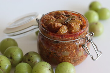 Amla Pickle or gooseberry pickle stored in a glass bottle. It is a spicy condiment made with Amla...