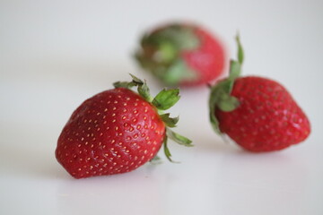 Fresh strawberries shot on white background. it is a Rosaceae family fruit.