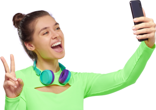 Pretty teenage girl with wireless headphones around neck, taking selfie for social networks