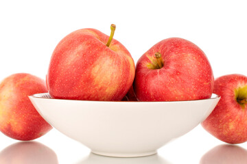 Four ripe red apples with white ceramic plate, macro, isolated on white background.