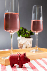 New Year's greetings with lucky clover, sparkling wine and lucky pigs