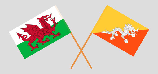 Crossed flags of Wales and Bhutan. Official colors. Correct proportion