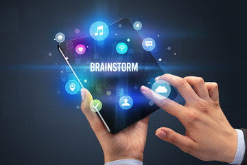 Businessman holding a foldable smartphone