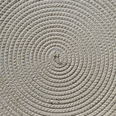 Fototapeta na wymiar Closeup photograph of concentric geometric pattern formed by woven natural fibers