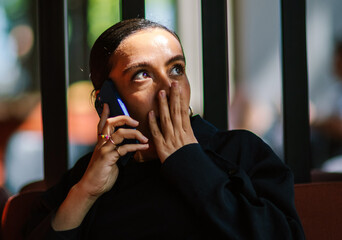 woman on the phone suprised 