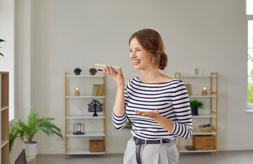Modern technologies. Smiling cheerful woman answers incoming call or leaves voice audio message...