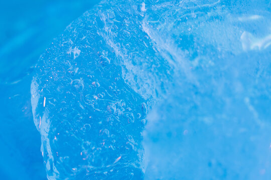 Global warming. Melting blue ice macro shot. Natural crystal clear flowing water. Creative background © golubovy