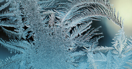 Abstract Christmas horizontal stories. Ice crystals on frozen window glass. Frost drawing. Dark blue tinted illustration. It's like a moonlit winter night. Frostwork and frosting pattern. Macro