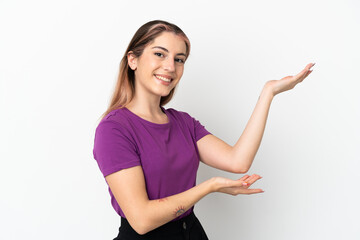 Young caucasian woman isolated on white background extending hands to the side for inviting to come