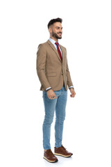 proud man with red tie and jacket looking away and smiling