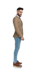 side view of bearded man in jacket looking to side and down