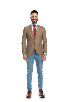 happy smart casual man with red tie standing and smiling