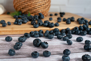 Fresh blueberries scattered on a wooden surface. selective focus
