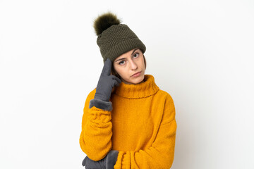 Young girl with winter hat isolated on white background thinking an idea