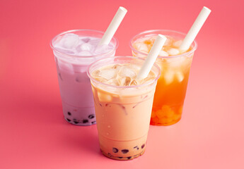 Three Different Types of Boba Tea on a Bright Pink Background