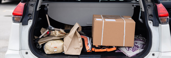 Office moving concept. Cartoon boxes in a car trunk © Angelov