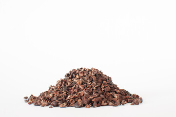 Profile view of natural and organic cacao nibs, shallow depth of filed on top of the heap, isolated...