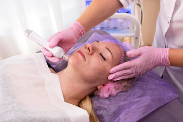 Obraz na płótnie Canvas Beautiful woman getting face vacuum procedure for healthy skin in spa salon. 