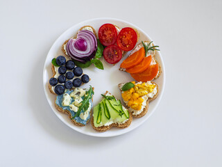 Rainbow sandwiches heart shape on white table. Breakfast bread rainbow sandwiches with colorful...