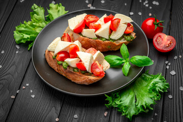 Bruschetta with cherry tomatoes, mozzarella cheese and pesto sauce.