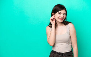 Fototapeta premium Young Russian woman isolated on green background laughing