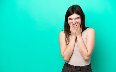 Young Russian woman isolated on green background happy and smiling covering mouth with hands