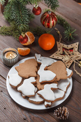 Delicious homemade Christmas cookies in the form of a rabbit and a Christmas tree on a wooden table decorated with New Year's decor.