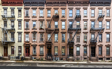 Block of historic apartment buildings crowded together on West 49th Street in the Hell's Kitchen neighborhood of New York City - obrazy, fototapety, plakaty
