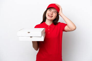 Young Russian pizza delivery picking up pizza boxes isolated on white background smiling a lot