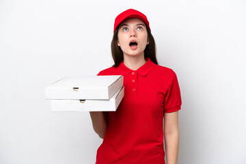 Young Russian pizza delivery picking up pizza boxes isolated on white background looking up and...