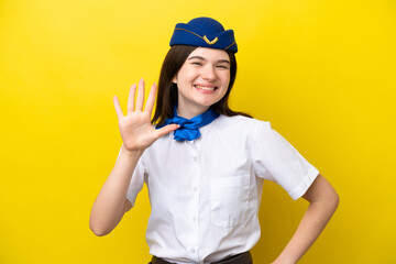Airplane stewardess Russian woman isolated on yellow background counting five with fingers