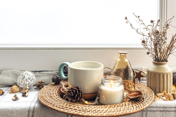 Cozy home composition with coffee cup and home decor details.