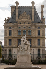 Paris, France - 09 16 2021: Tuileries garden. View of sculpture of Jules ferry in the park and La Defense buildings behind
