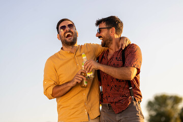 Two handsome male friends walking along the beach and hanging out talking
Summer time stock photo