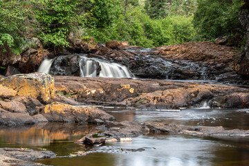 The top portion of Mink Falls along the Trans Canada Highway north of Lake Superior is seen nestled...