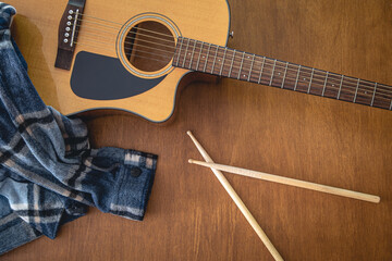 Fototapeta premium Music composition with acoustic guitar and drumsticks, top view.