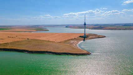 Aerial photography over Techirghiol lake with a patch of land and the radio TV relay on it at...