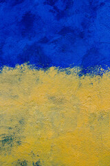 Flag of Ukraine painted on the facade of the house. Support for Ukraine. Symbols of Ukraine. Concept of Ukraine