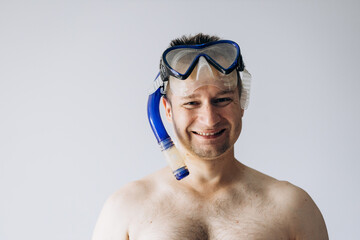 Handsome man in diving mask standing and looking at camera.