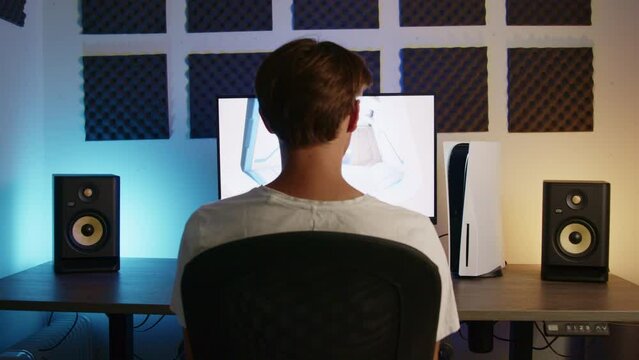 Boy Laying down his PS5 controller and walking away after gaming on his PlayStation 5 in an RGB LED room at night, Wide