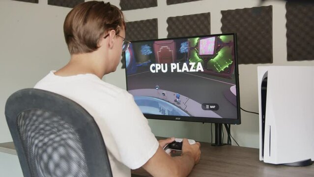 Boy gaming on a PlayStation 5 with a PS5 controller in the afternoon, Side view