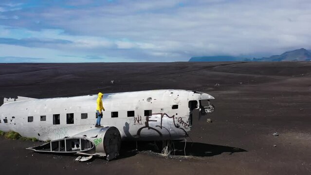 person walking on a plane wreck in iceland