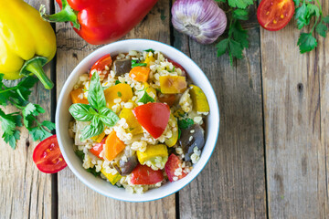 Bulgur salad with vegetables. Bulgur with vegetables. Wooden background