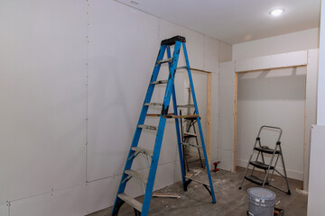 Plasterboard is being installed in a room with drywall is ready for taping in the room