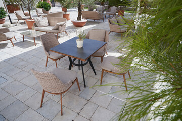 Cozy outdoor restaurant with wicker furniture