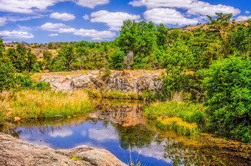 Fototapeta na wymiar Reflections on pond at Charons Garden Wilderness Wichita Mountains Wildlife Refuge Lawton OK
